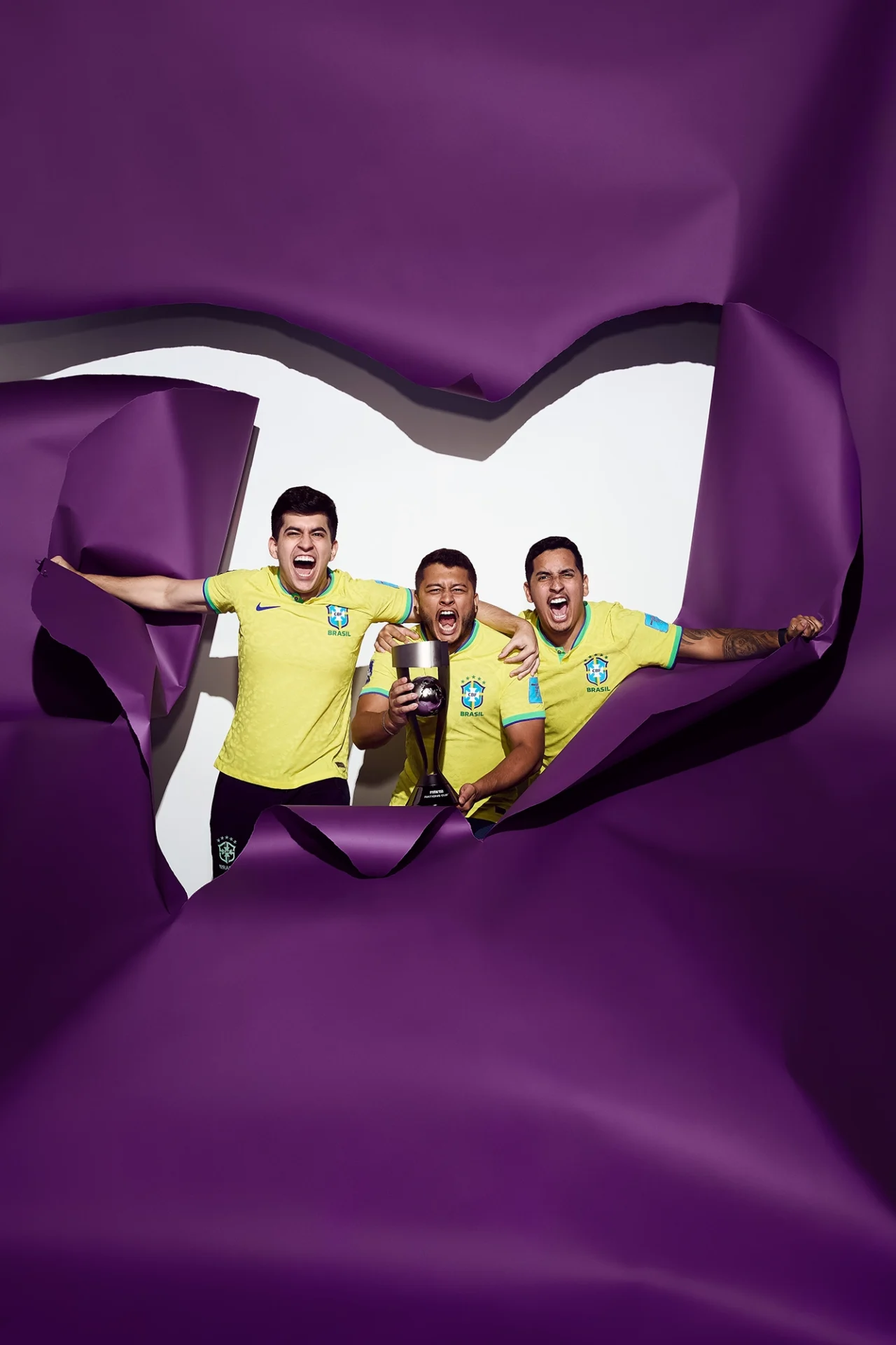 Paulo Roberto Xavier de Brito Neto (PauloNeto999), Pedro Henrique Resende Soares (Resende) and Paulo Henrique de Souza Ferreira Chaves (PHZin) of Team Brazil pose with the FIFAe Nations Cup Winner's Trophy during day four of the FIFAe Nations Cup 2023 on July 14, 2023 in Riyadh, Saudi Arabia.